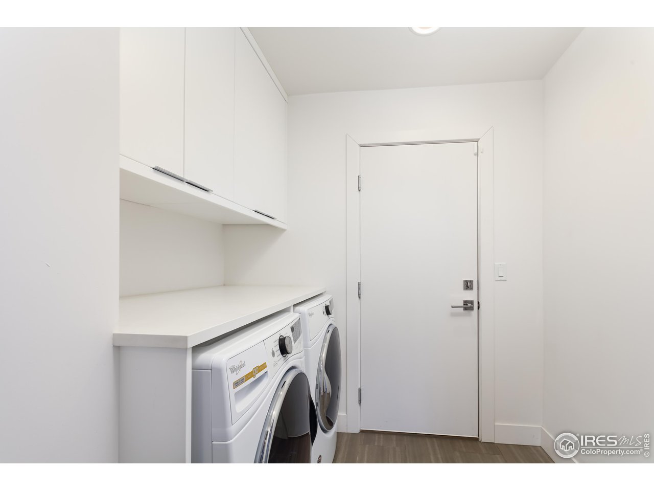 5315 Centennial Trail Boulder, CO 80303 - Photo 32 of 40 Tiled laundry room conveniently just off of the kitchen and at the 2 car garage entry. Bedroom 3/office/gym entry from here.