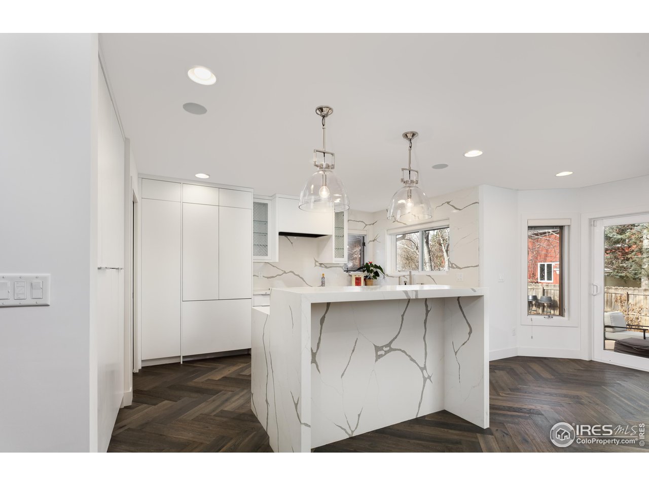 5315 Centennial Trail Boulder, CO 80303 - Photo 9 of 40 Waterfall quartz island with barstool seating. Cabinet clad Thermador appliances. 6 burner stovetop. Dining alcove open to the backyard for indoor/outdoor entertaining.
