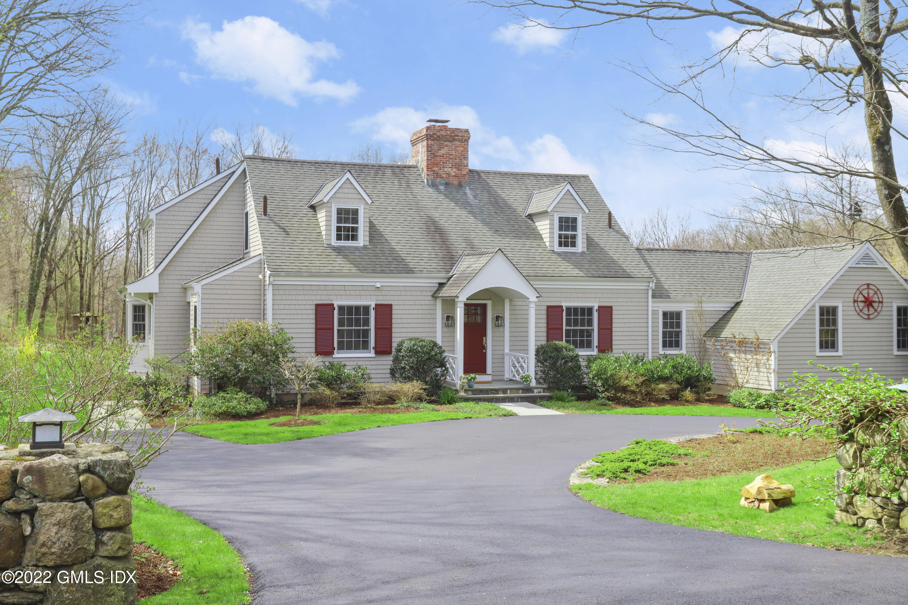a front view of multiple houses with yard