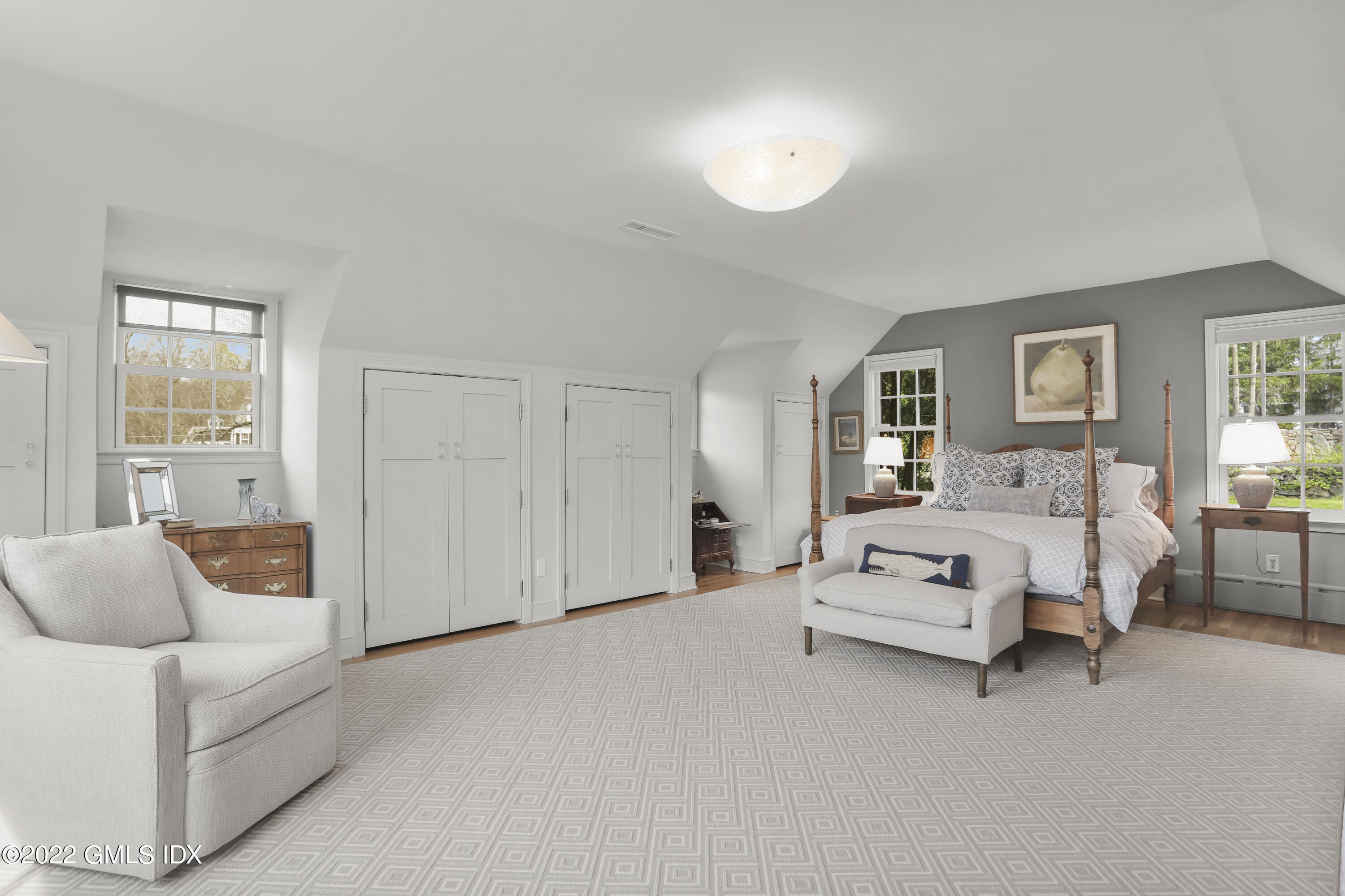 65 Doubling Road Greenwich, CT 06830 - Photo 16 of 33 a spacious bedroom with a bed and a couch