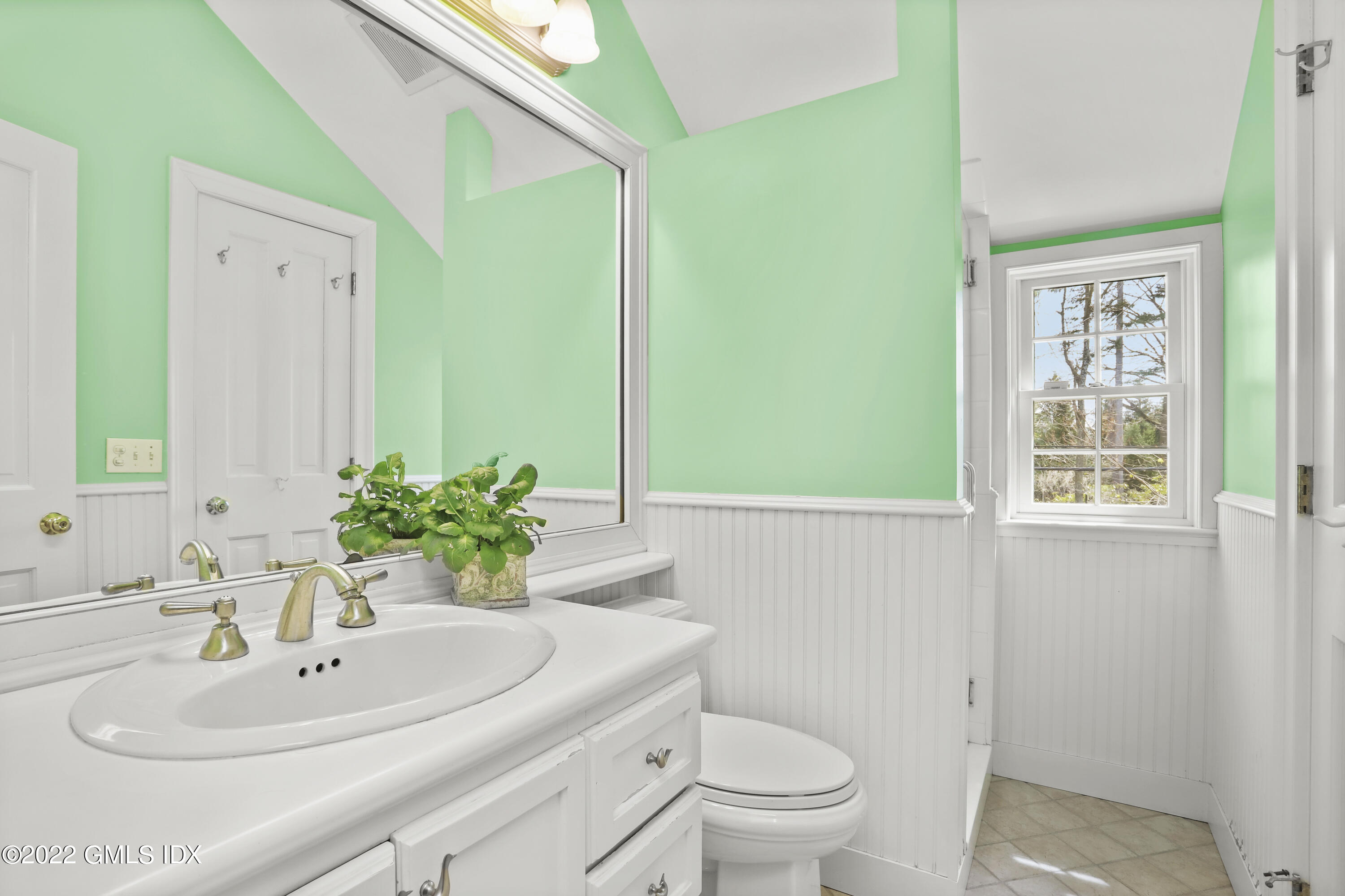 65 Doubling Road Greenwich, CT 06830 - Photo 22 of 33 a bathroom with a sink toilet and mirror