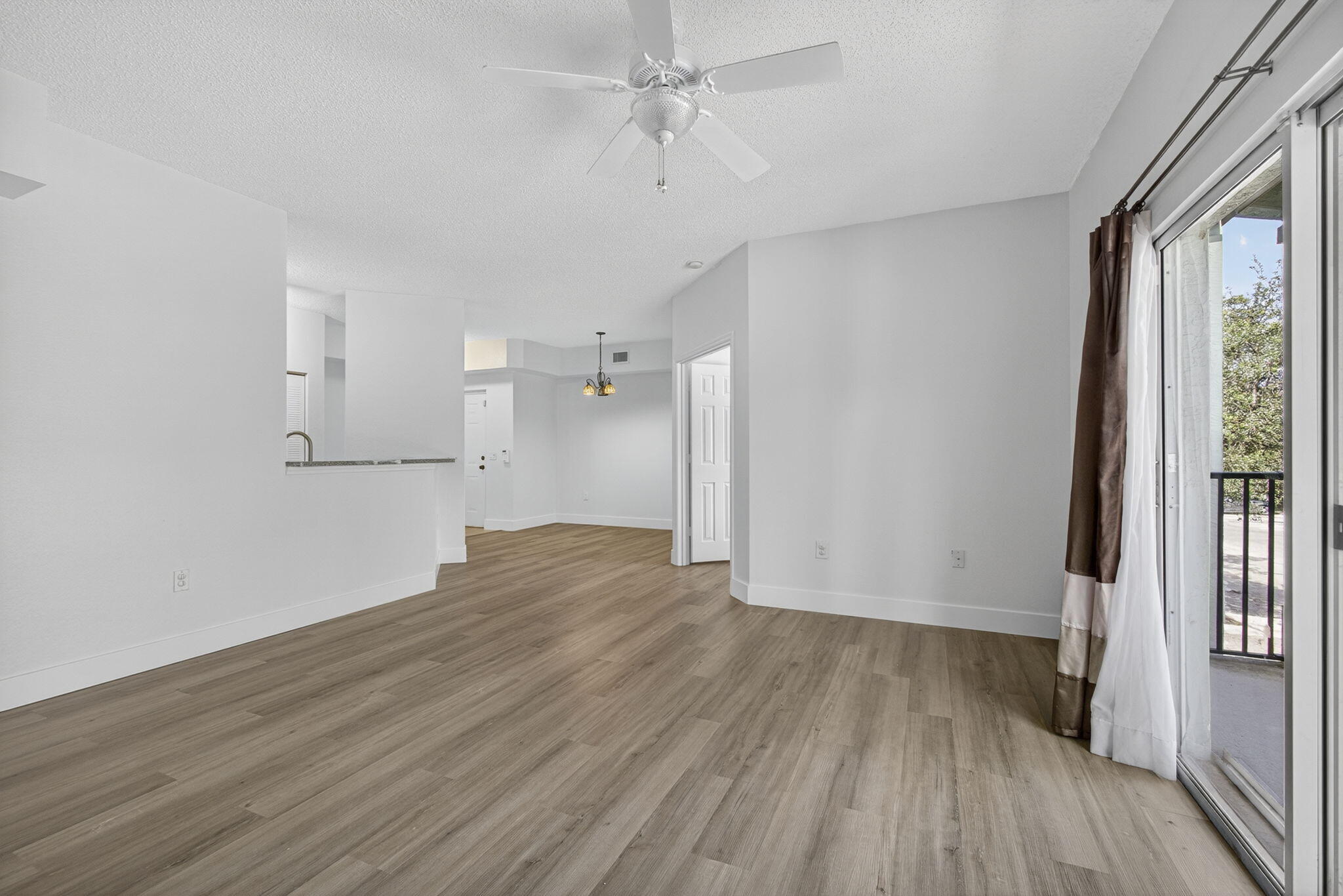 340 Crestwood Circle, Unit 201 Royal Palm Beach, FL 33411 - Photo 13 of 41 an empty room with wooden floor and windows