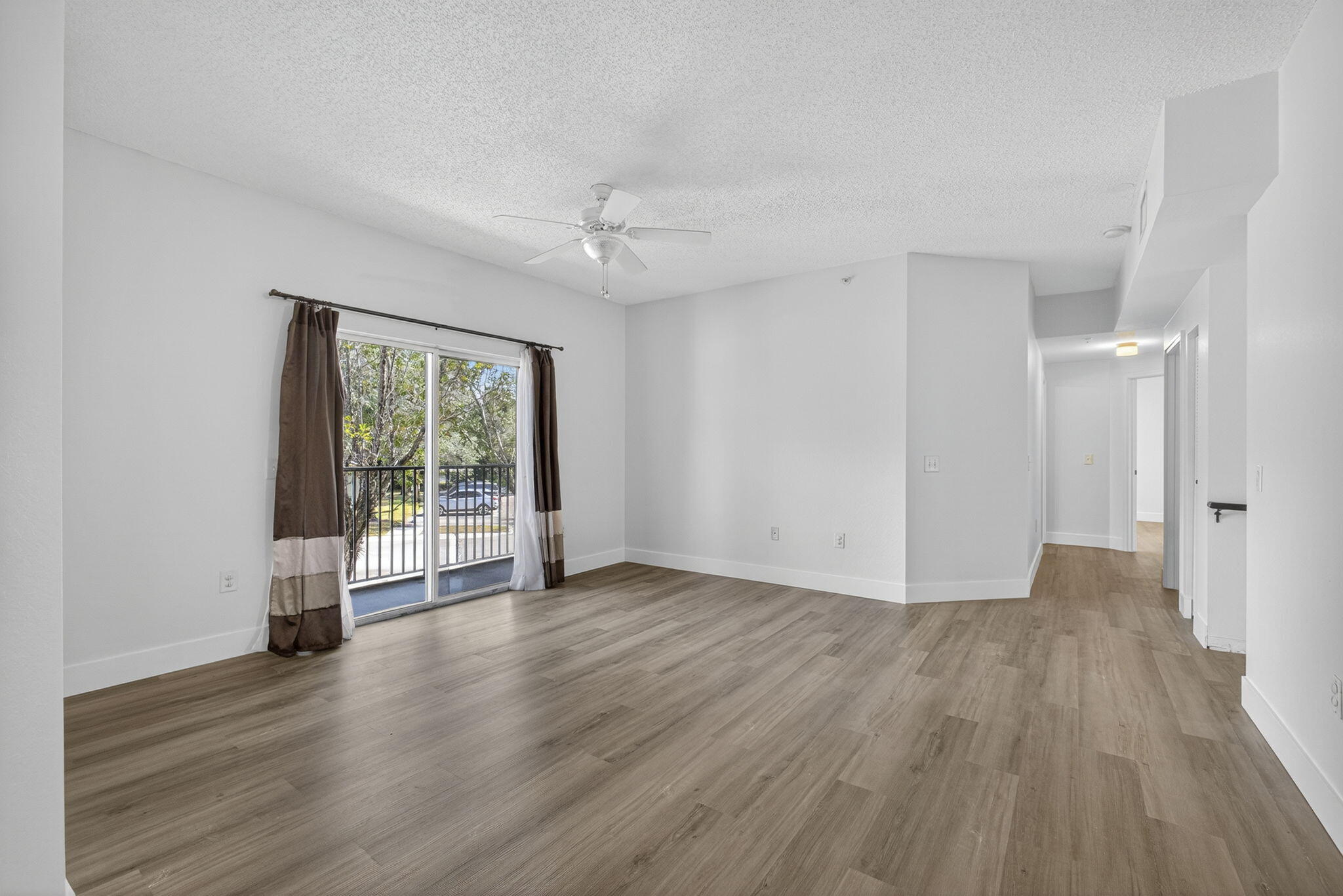 340 Crestwood Circle, Unit 201 Royal Palm Beach, FL 33411 - Photo 14 of 41 a view of an empty room with wooden floor and a window