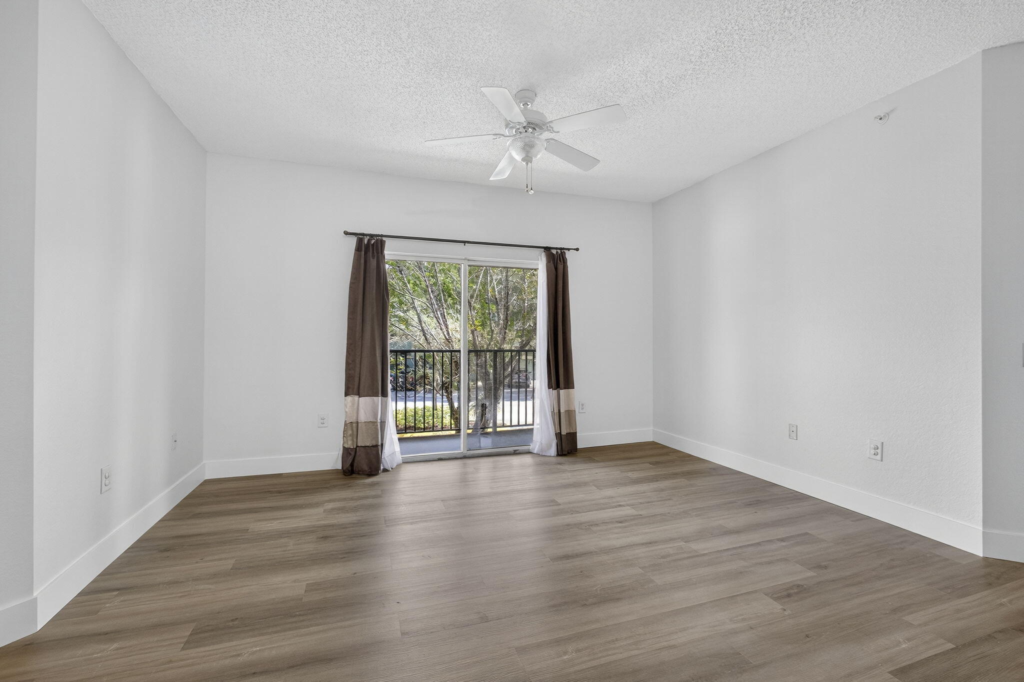 340 Crestwood Circle, Unit 201 Royal Palm Beach, FL 33411 - Photo 15 of 41 a view of an empty room with wooden floor and a window