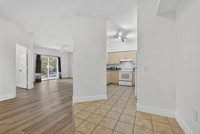 a view of a kitchen with wooden floor and a kitchen