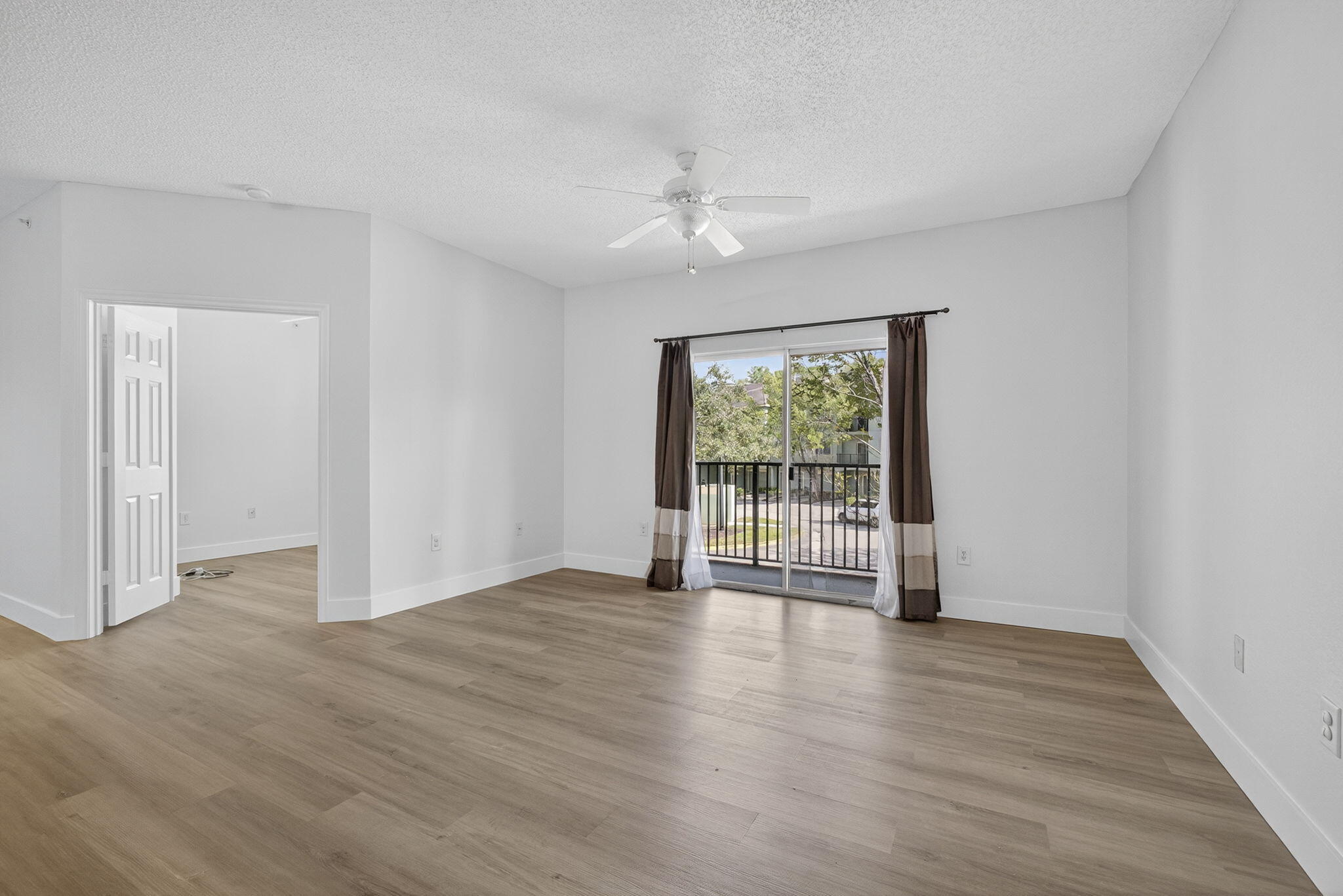 340 Crestwood Circle, Unit 201 Royal Palm Beach, FL 33411 - Photo 17 of 41 a view of an empty room with wooden floor and a window