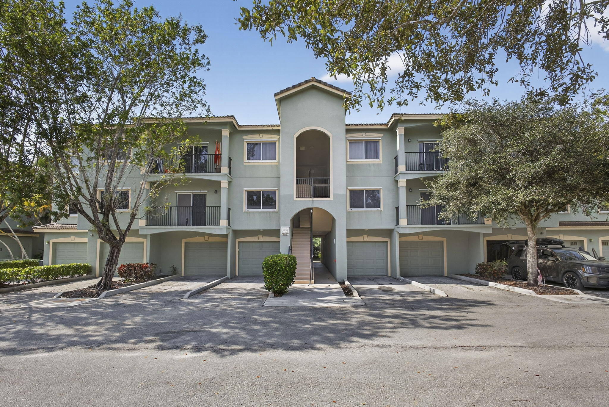 340 Crestwood Circle, Unit 201 Royal Palm Beach, FL 33411 - Photo 2 of 41 a front view of a house with garden