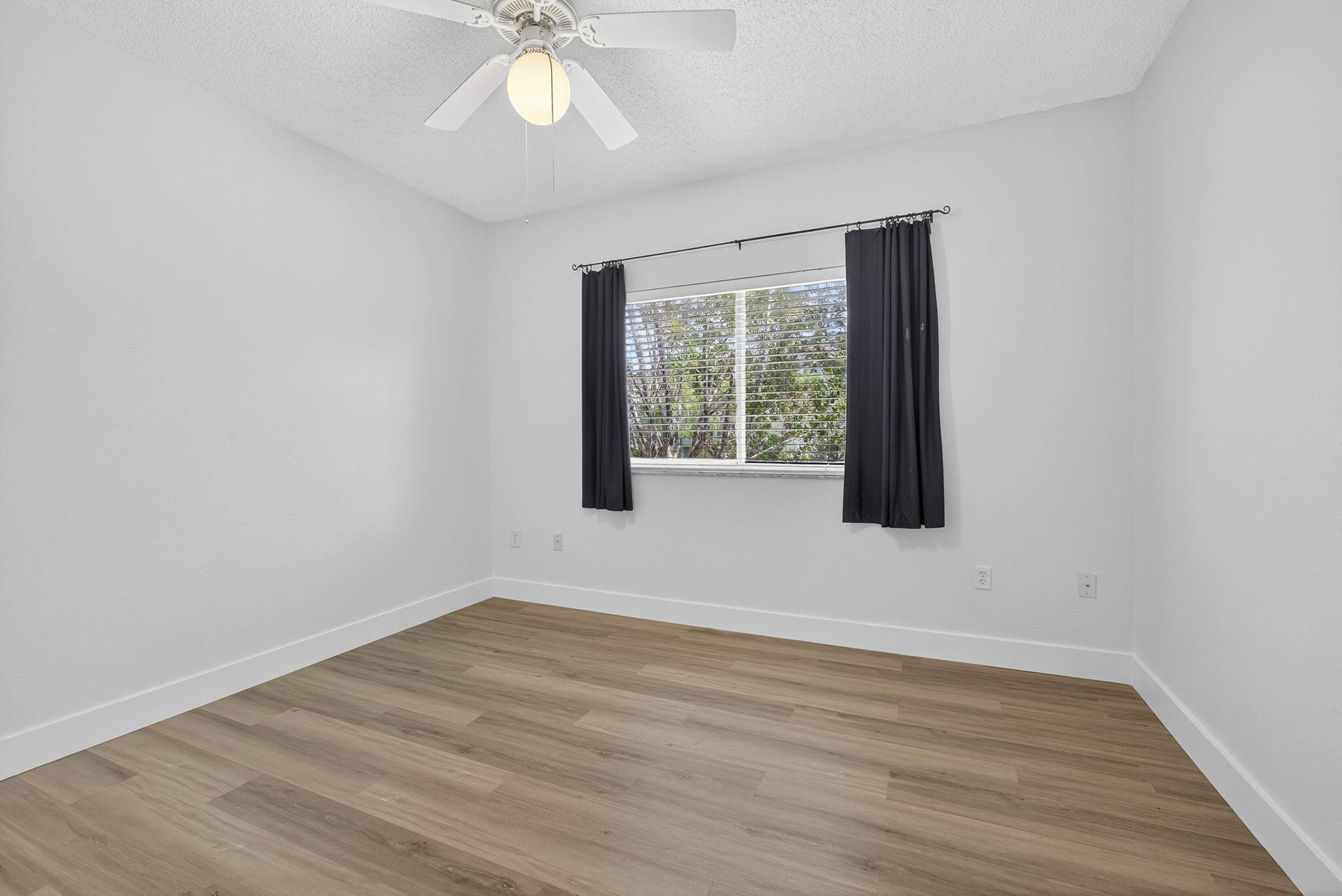 340 Crestwood Circle, Unit 201 Royal Palm Beach, FL 33411 - Photo 28 of 41 a view of an empty room with wooden floor and a window