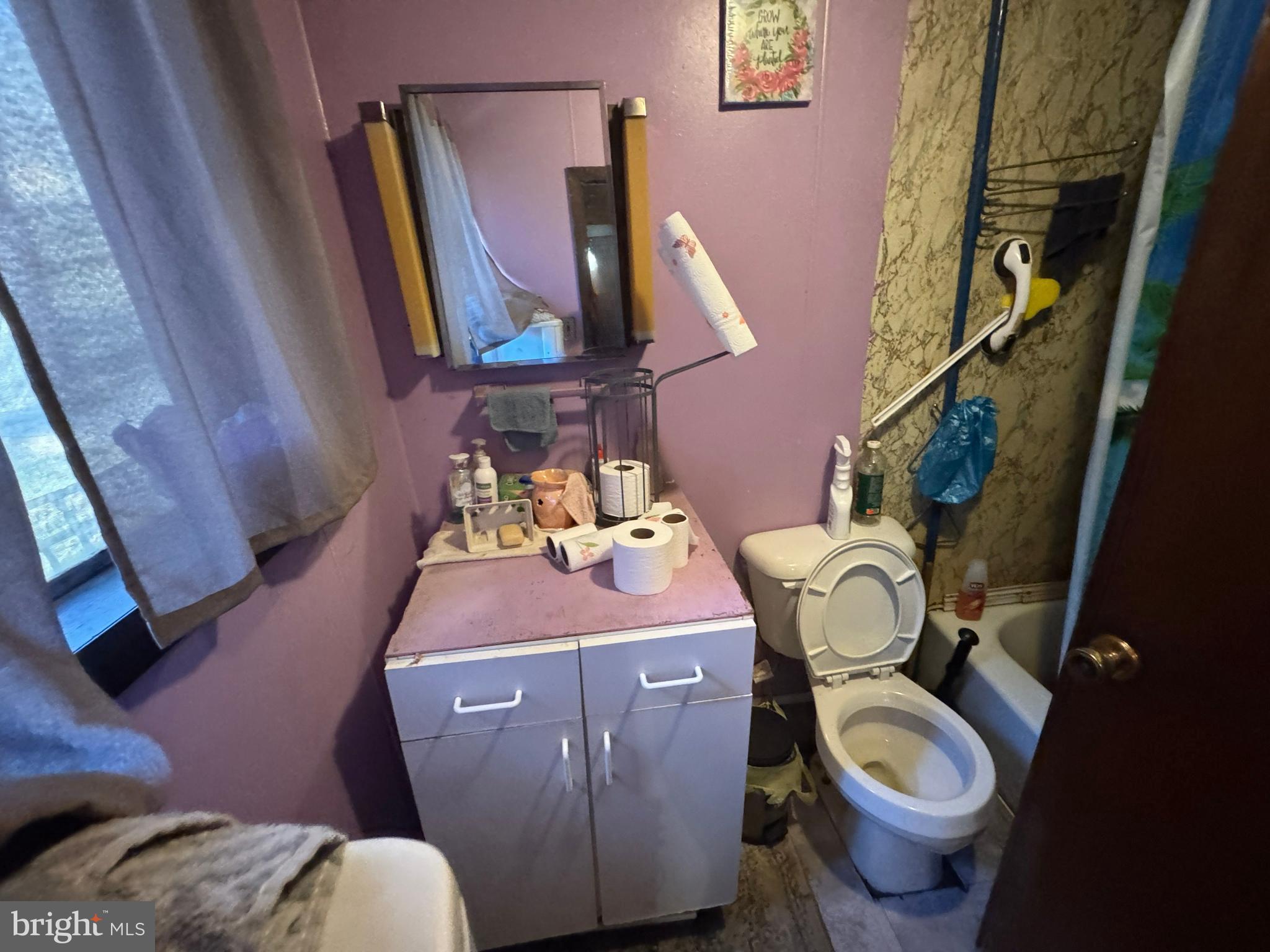 212 Benton Road East Freedom, PA 16637 - Photo 7 of 8 a bathroom with a toilet sink and mirror