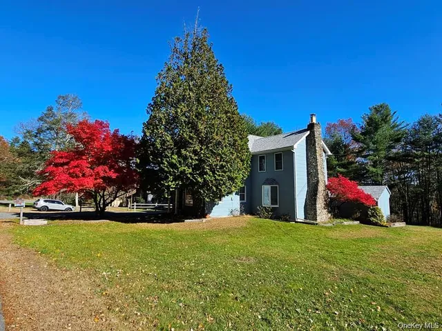 a view of a house with a yard and garage