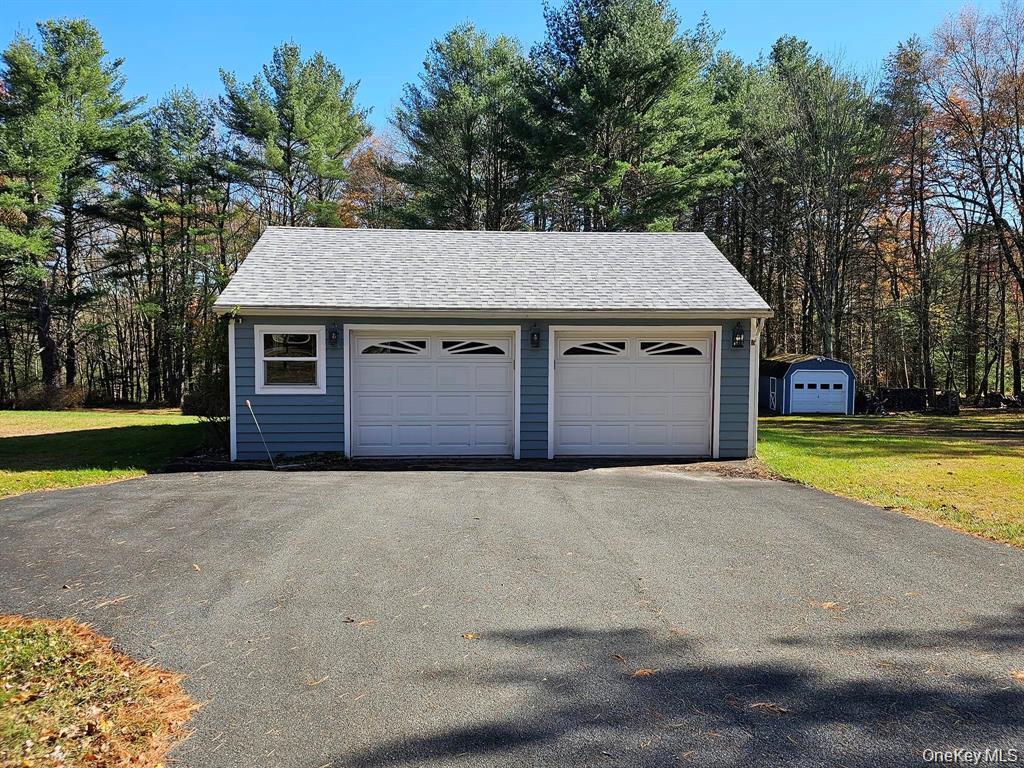 107 Eldred-Yulan Road Eldred, NY 12732 - Photo 5 of 24 a front view of a house with a yard and garage