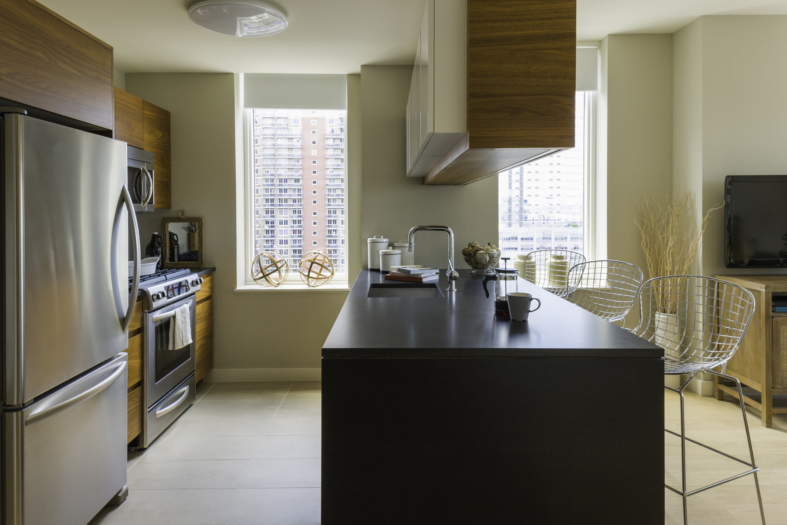 a kitchen with refrigerator a stove a sink a counter space and cabinets