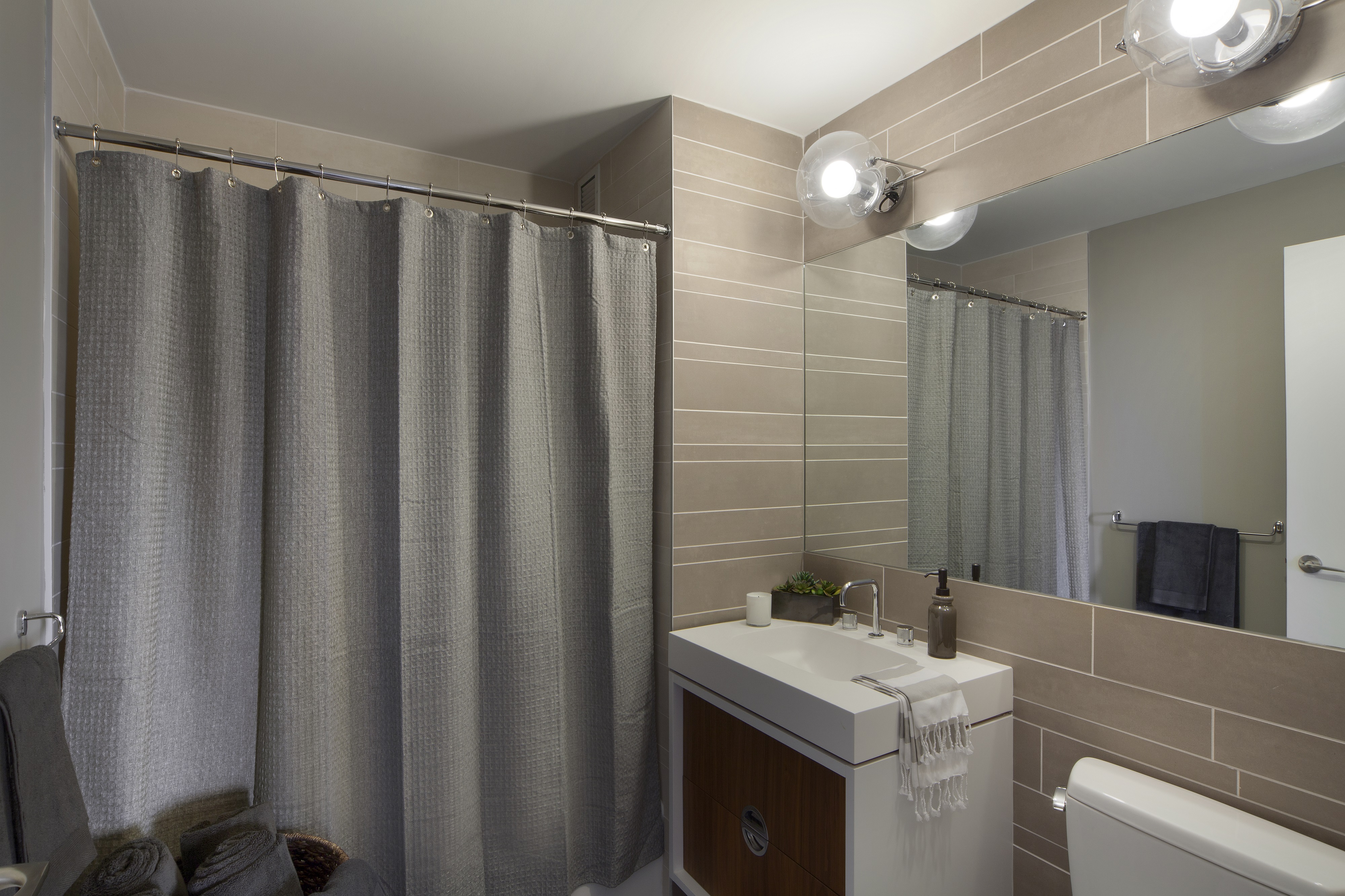 550 West 45th Street, Unit 2513 Manhattan, NY 10036 - Photo 4 of 22 a bathroom with a sink a toilet and shower