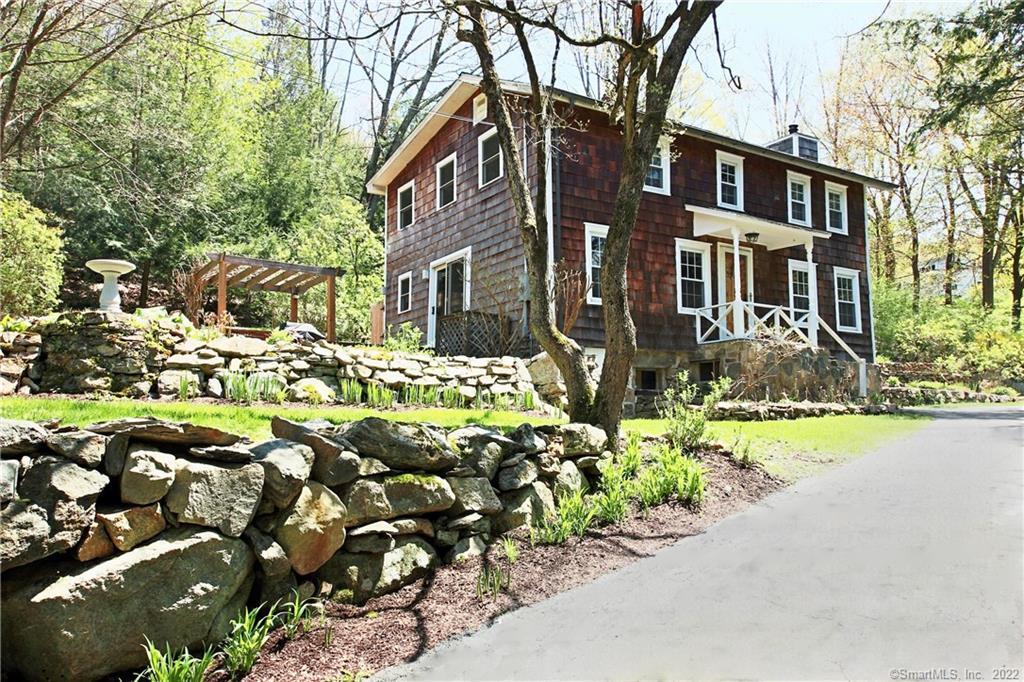 126 Old Mill Road Wilton, CT 06897 - Photo 1 of 1 a front view of a house with a yard and outdoor seating