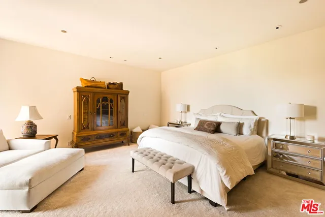 a bed room with a bed and a television