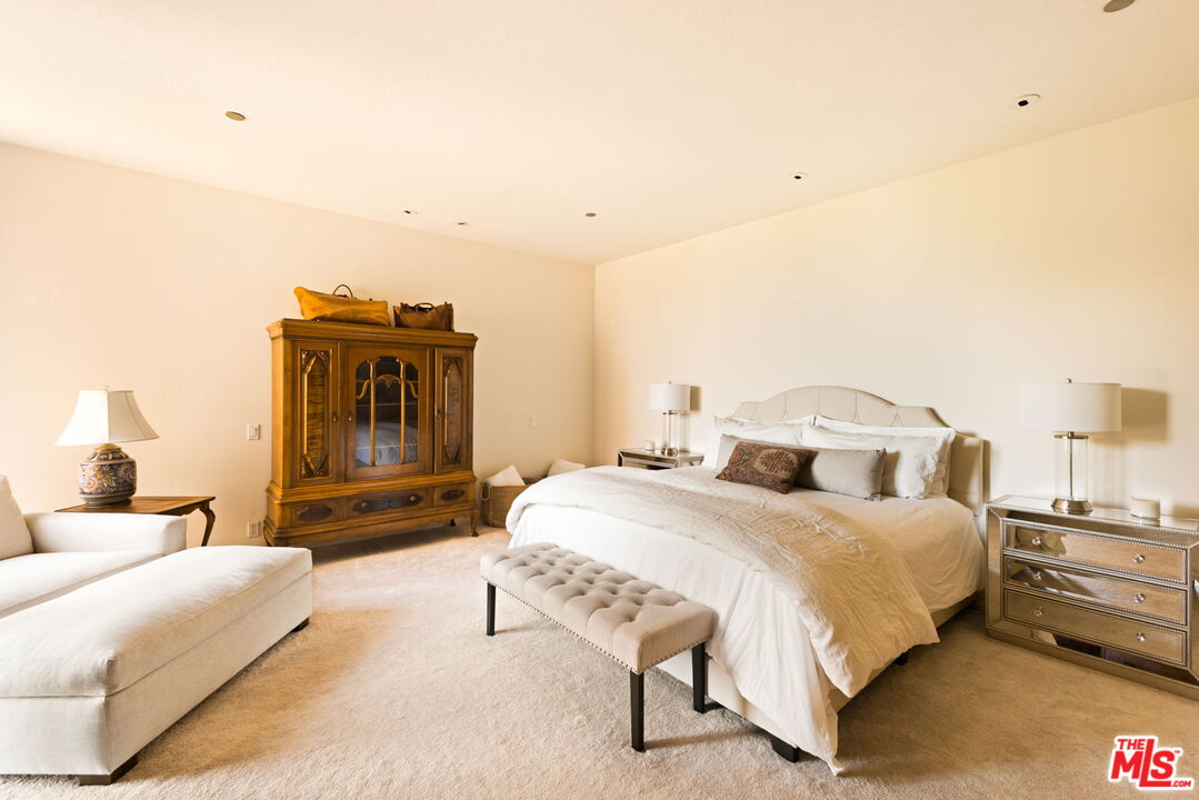 300 North Swall Drive, Unit 353 Beverly Hills, CA 90211 - Photo 18 of 31 a bedroom with a bed and a couch