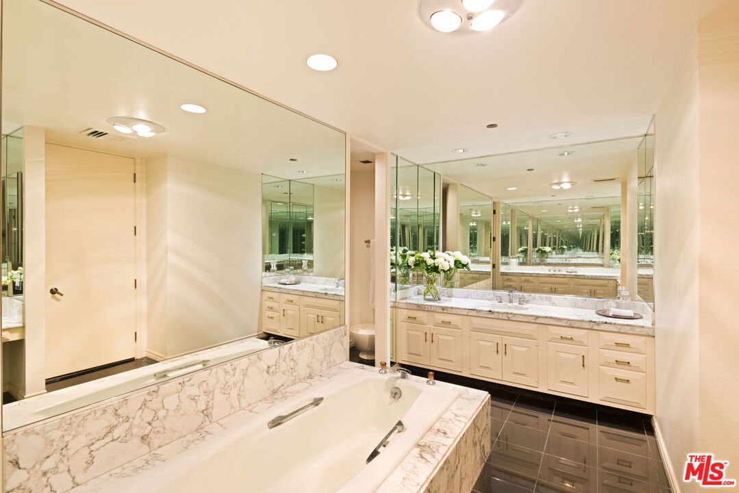 300 North Swall Drive, Unit 353 Beverly Hills, CA 90211 - Photo 21 of 31 a bathroom with a tub shower and sink