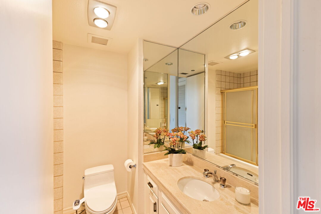 300 North Swall Drive, Unit 353 Beverly Hills, CA 90211 - Photo 25 of 31 a bathroom with a sink vanity mirror and toilet