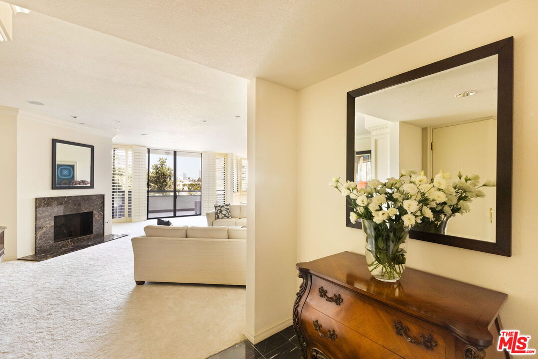 300 North Swall Drive, Unit 353 Beverly Hills, CA 90211 - Photo 5 of 31 a living room with furniture and a fireplace