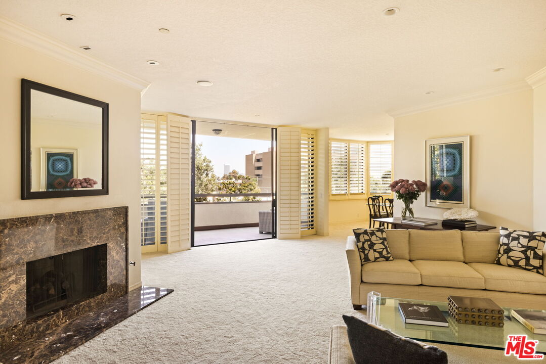 300 North Swall Drive, Unit 353 Beverly Hills, CA 90211 - Photo 7 of 31 a living room with furniture a fireplace and a large window