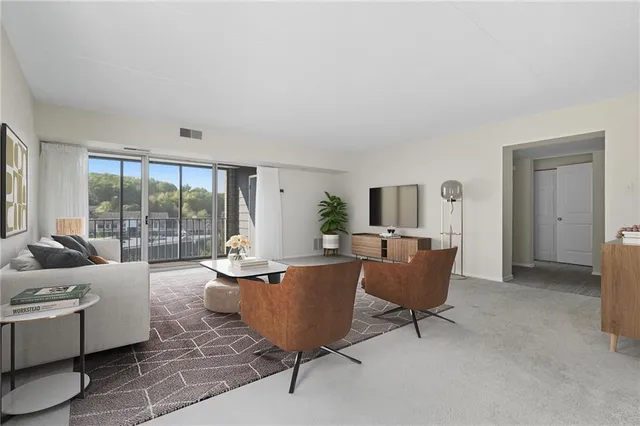 a living room with furniture and a large window