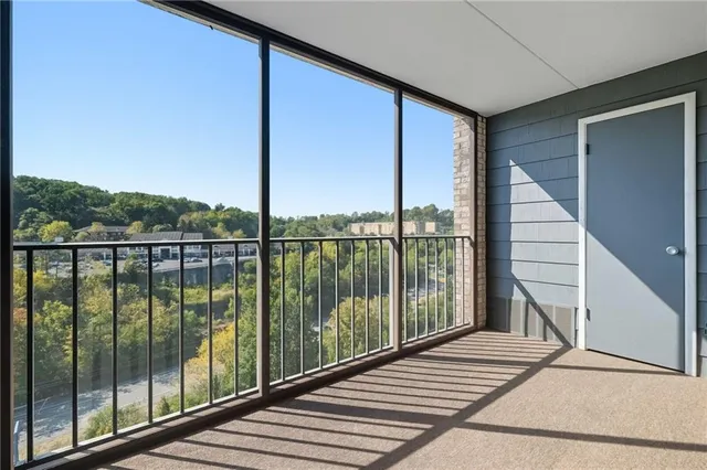 a view of a balcony with floor to ceiling windows with wooden floor