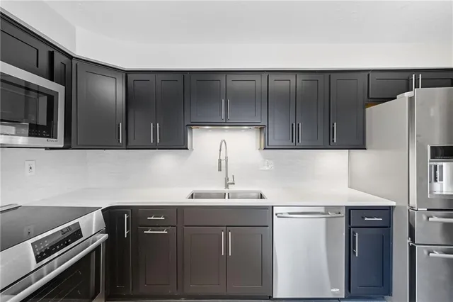 a kitchen with a sink and a refrigerator