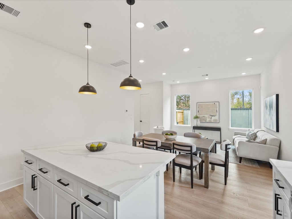 243 Rebecca Street, Unit F Houston, TX 77022 - Photo 11 of 26 a kitchen with a table and chairs