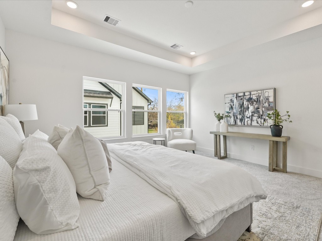 243 Rebecca Street, Unit F Houston, TX 77022 - Photo 14 of 26 a spacious bedroom with a large bed and a large window