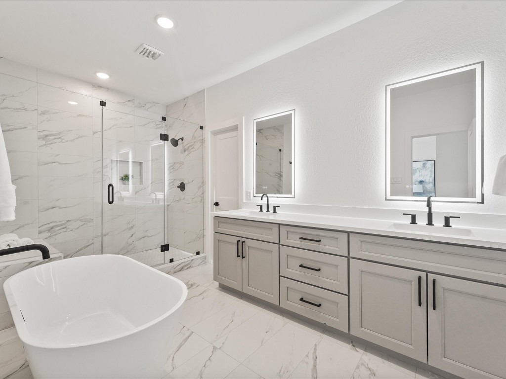 243 Rebecca Street, Unit F Houston, TX 77022 - Photo 15 of 26 a spacious bathroom with double sink a a mirror a bathtub and shower