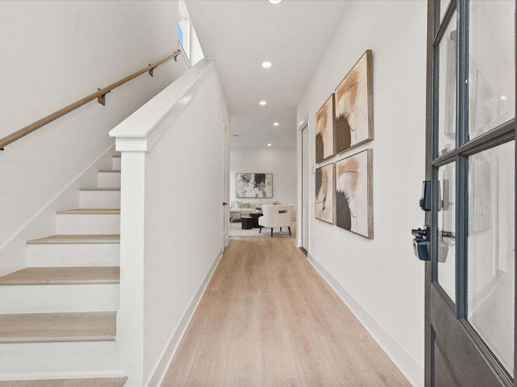 243 Rebecca Street, Unit F Houston, TX 77022 - Photo 5 of 26 a view of a hallway with wooden floor and staircase