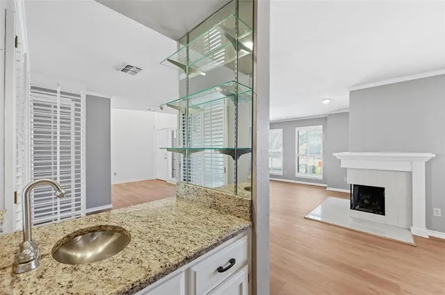 a kitchen with granite countertop a stove a oven and a wooden floor