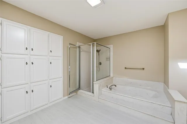 a bathroom with a bathtub and a shower