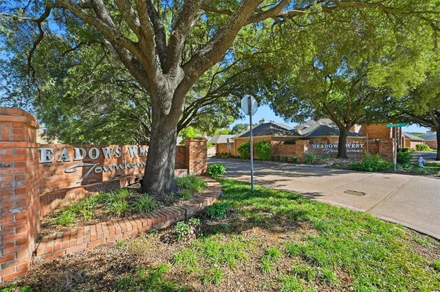 a view of a backyard with large trees