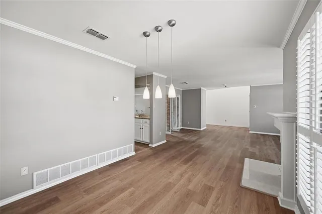 a view of a room with wooden floor