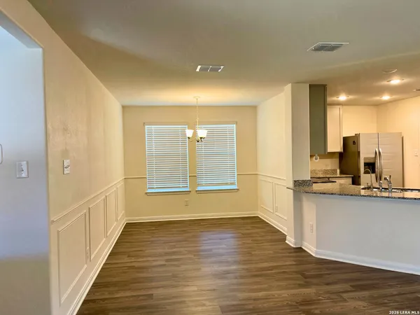 a view of a kitchen with a sink and cabinets