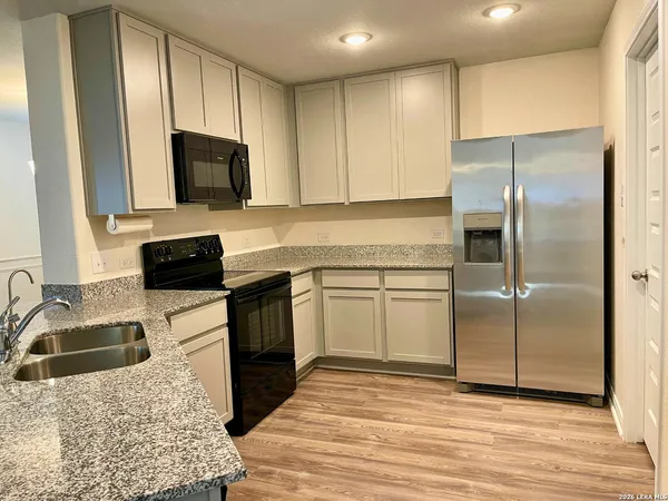 a kitchen with a sink stove and refrigerator