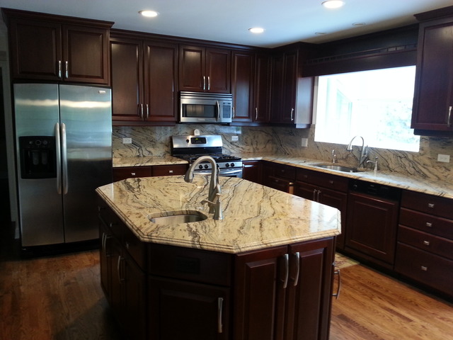 1718 Appleby Road Inverness, IL 60067 - Photo 12 of 24 a kitchen with kitchen island granite countertop a sink counter space appliances and cabinets