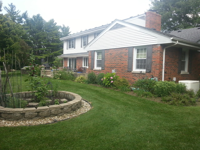 1718 Appleby Road Inverness, IL 60067 - Photo 22 of 24 a view of a white house next to a yard with plants and trees