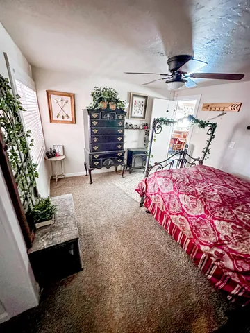 a bedroom with bed and window