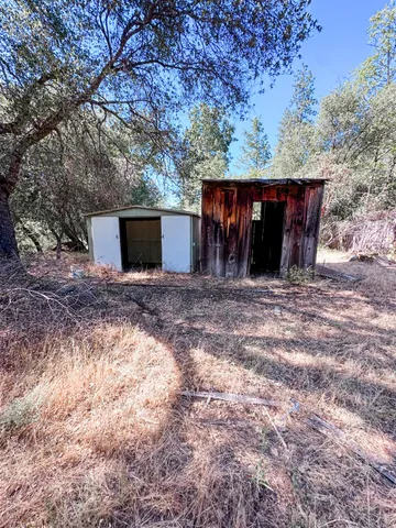 a view of a wooden floor and yard in the back yard