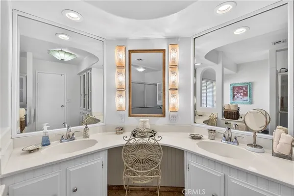 a bathroom with a sink double vanity and a mirror
