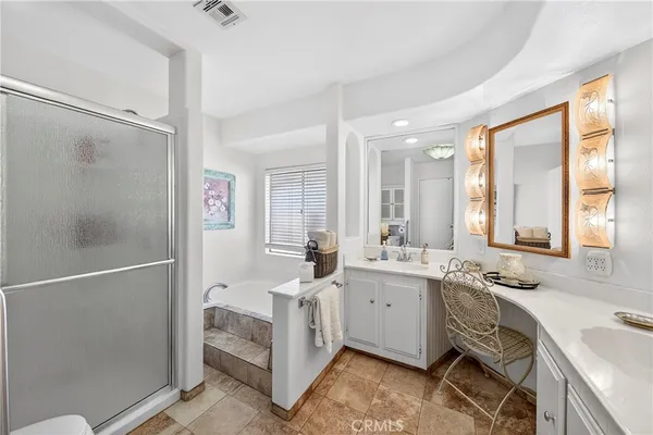 a bathroom with a double vanity sink a mirror and a shower