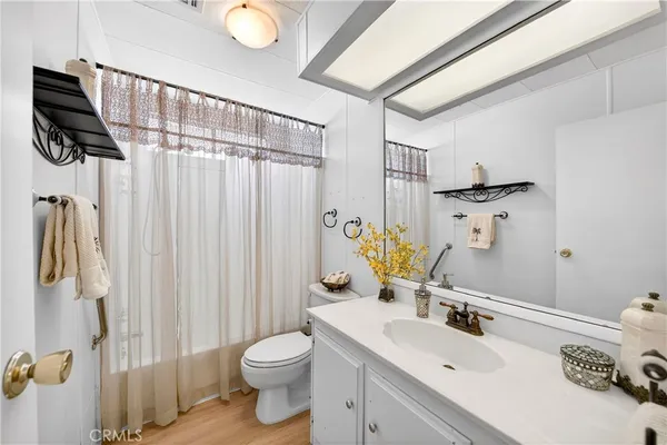 a bathroom with a sink vanity granite and toilet
