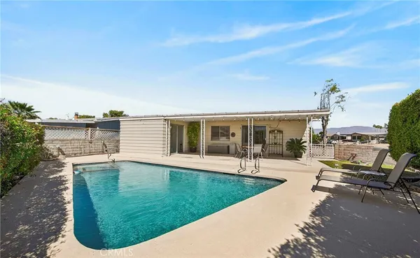 a view of a swimming pool with a lounge chair