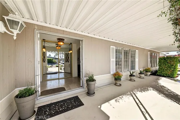 a view of a patio with table and chairs potted plants