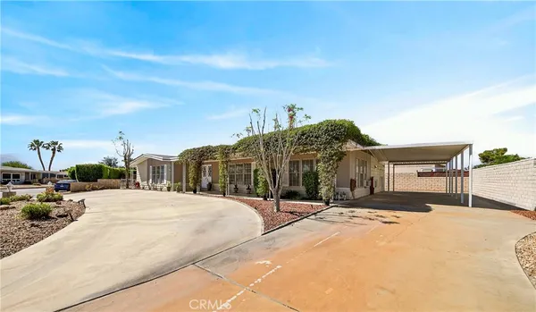 an aerial view of a house with a garden and lake view