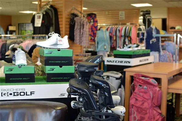 a front view of a building with a garden and plants