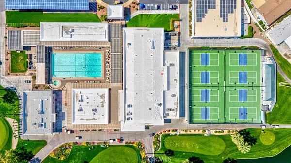 a front view of a house with garden and parking