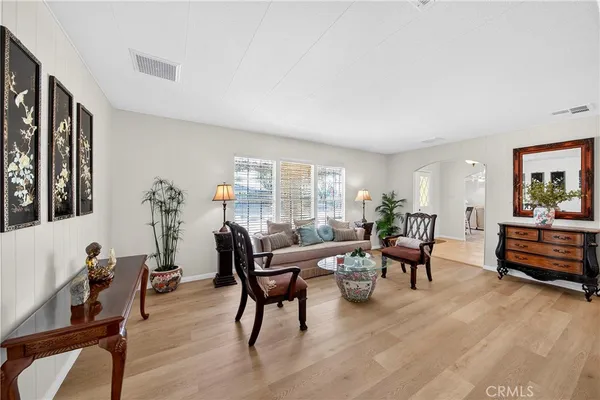 a living room with furniture and a wooden floor